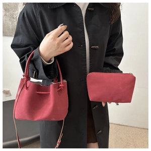 Red retro bucket bag set with matching zipper pouch and knotted handle detail