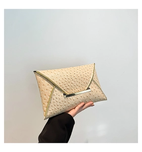 Detail of beige ostrich embossed leather envelope clutch bag with gold metallic fastener