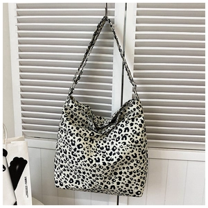 Detail of large leopard print tote bag featuring an adjustable strap and soft fabric