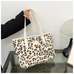 Close-up of leopard print plush tote bag with white leather straps and matching pouch