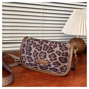 Detailed leopard print bag with brown leather trim and retro geometric wide strap