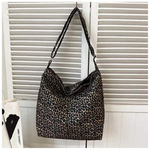 Detail of leopard print tote bag with adjustable shoulder strap and large front pockets