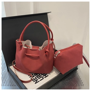 Detail of red leather bucket bag set with matching pouch and round top handle