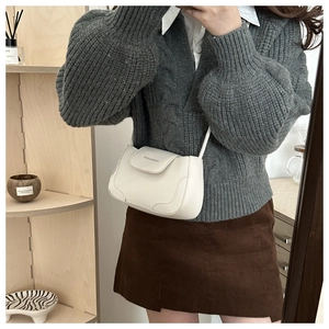 Detail shot of the white minimalist crossbody bag showing the smooth PU leather finish