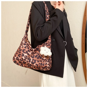 Détail du sac hobo à motif léopard avec un joli pendentif mouton en peluche blanche