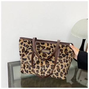Detail of leopard print plush tote bag with matching round mini coin purse and leather strap