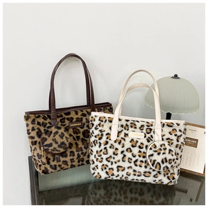 Detail view of leopard print plush tote bags with matching coin purse and leather tag