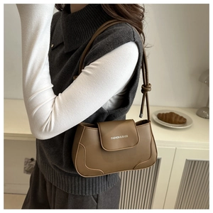 Close-up of khaki leather underarm bag with Fashion & Bags logo and knot strap detail
