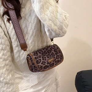Retro leopard print crossbody saddle bag with a decorative wide woven shoulder strap