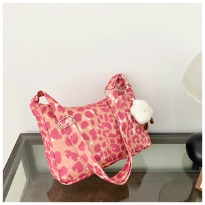 Détail du sac hobo à imprimé léopard rose avec bandoulière et breloque mouton doux