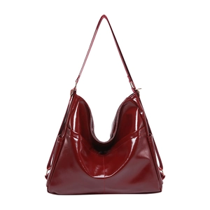 Fashionable dark red glossy patent leather tote bag with spacious interior for women