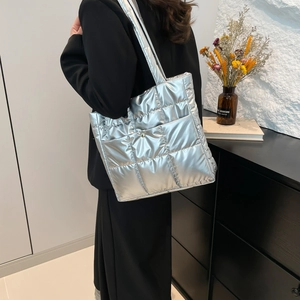 Chic silver quilted down tote bag with a metallic finish for winter casual styling