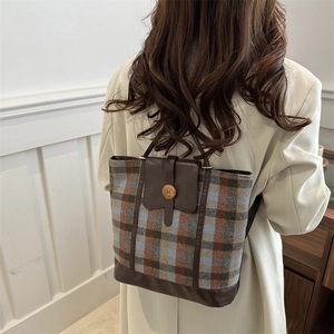 Retro British style wool plaid backpack with brown leather trim and metal N buckle