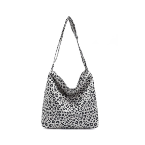Large black and white leopard print canvas hobo bag with adjustable shoulder strap