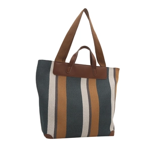 Large striped canvas tote bag with brown leather handles and shoulder strap for travel