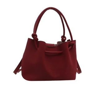 Fashionable dark red pleated bucket bag with a knotted handle and soft leather texture