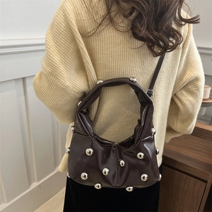 Chocolate brown leather shoulder bag with large silver studs and slouchy designer texture