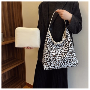 Detail of trendy leopard print tote bag with a small beige leather zip pouch
