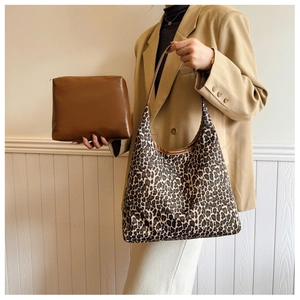Detail view of leopard print tote bag set featuring matching brown makeup pouch