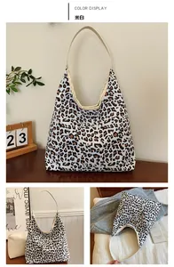 Detail shot of large leopard print tote bag with off-white straps and durable canvas texture