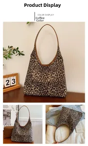 Close-up of leopard print tote bag with brown leather edges and long shoulder strap