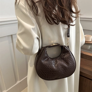 Retro dark brown woven crescent hobo bag with gold metal clasp and crossbody strap