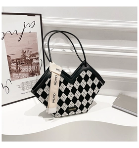 Detail of checkered tote bag with V-cut opening and branded ribbon decoration