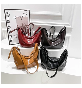 Detailed row of Hobo shoulder bags in burgundy brown caramel and black leather