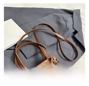 Detail showing high-quality leopard print texture and durable leather handle attachments