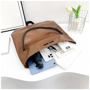 Brown tote bag interior showing large capacity for tablet, umbrella and daily items