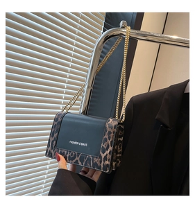 Detail of a leopard print flap bag with gold chain strap and Fashion & Bags text logo
