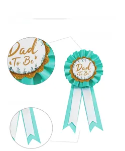 Detail of the Dad To Be rosette badge with Tiffany blue ribbon and gold glitter frame
