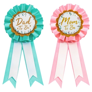 Floral rosette badges set with gold Dad To Be and Mom To Be text for baby shower parties