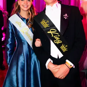 Detail of satin King and Queen sashes with gold foil lettering for party celebrations