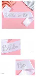 Close-up of Bride to Be sash with silver glitter lettering on white satin fabric
