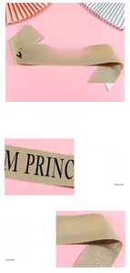 Detailed macro view of champagne gold glitter Prom Princess sash with elegant black lettering