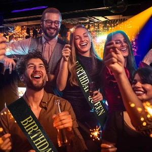 Birthday Queen sash in black glitter fabric with bold gold lettering for party celebrations