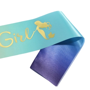 Macro view of gradient satin sash with gold foil Girl text and mermaid silhouette