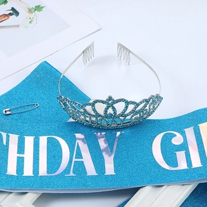 Detail of silver birthday girl crown with blue rhinestones and matching glitter sash