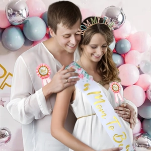 Macro detail of Baby Shower sash set with floral prints and Mom To Be gold headband