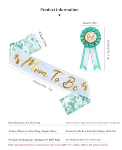 Detail of Mom To Be sash and Dad To Be badge set with gold lettering and glitter fabric