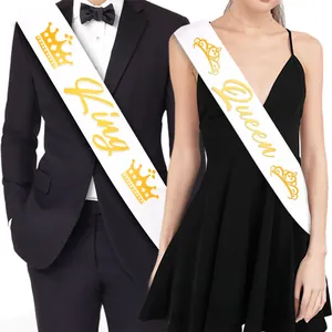 Detailed view of white King and Queen party sashes with elegant gold foil lettering