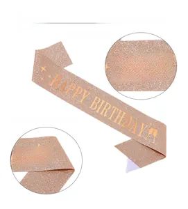 Close-up of rose gold glitter fabric birthday sash with gold HAPPY BIRTHDAY text