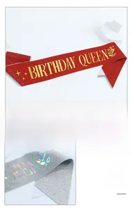 Close-up of sparkling Birthday Queen sash with glitter texture and gold lettering