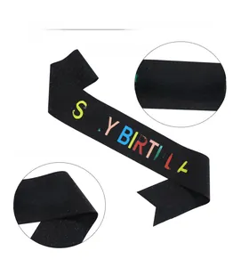Detail of black glitter birthday sash featuring colorful IT'S MY BIRTHDAY printing