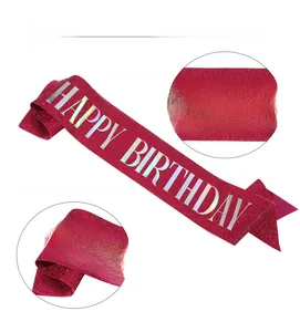 Macro detail of pink glitter satin birthday sash with silver holographic lettering