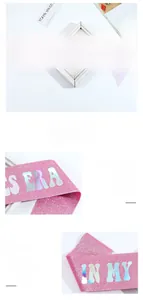 Detailed texture of pink glitter sash with holographic IN MY THIRTIES ERA text