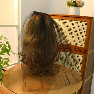 Detail view of the black mesh bridal veil with fine netting texture on a brunette mannequin
