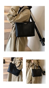 Detail of black woven tote bag with leather base and elegant brand plate for women
