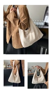 Detail view of a soft white plush faux shearling tote bag with leather shoulder straps
